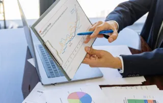 Free Business professionals discussing financial graphs and charts in an office setting. Stock Photo