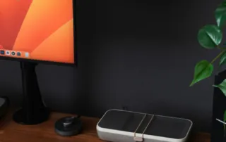a desk with a laptop, keyboard, mouse and a monitor